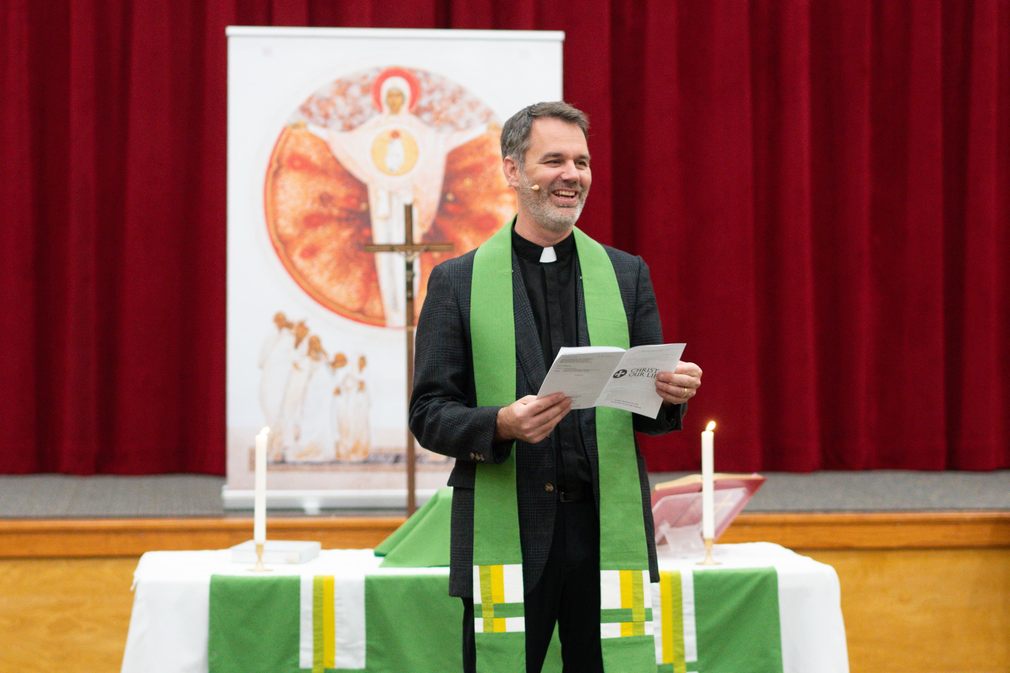 Tanner smiles while leading the liturgy.